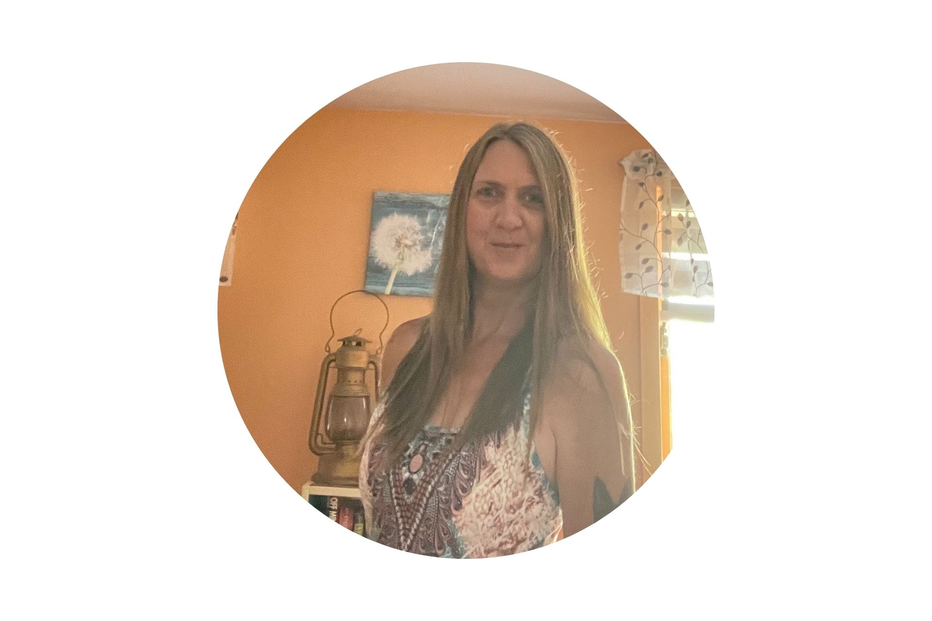 Tracy in her creamsicle colored room smiling for the camera