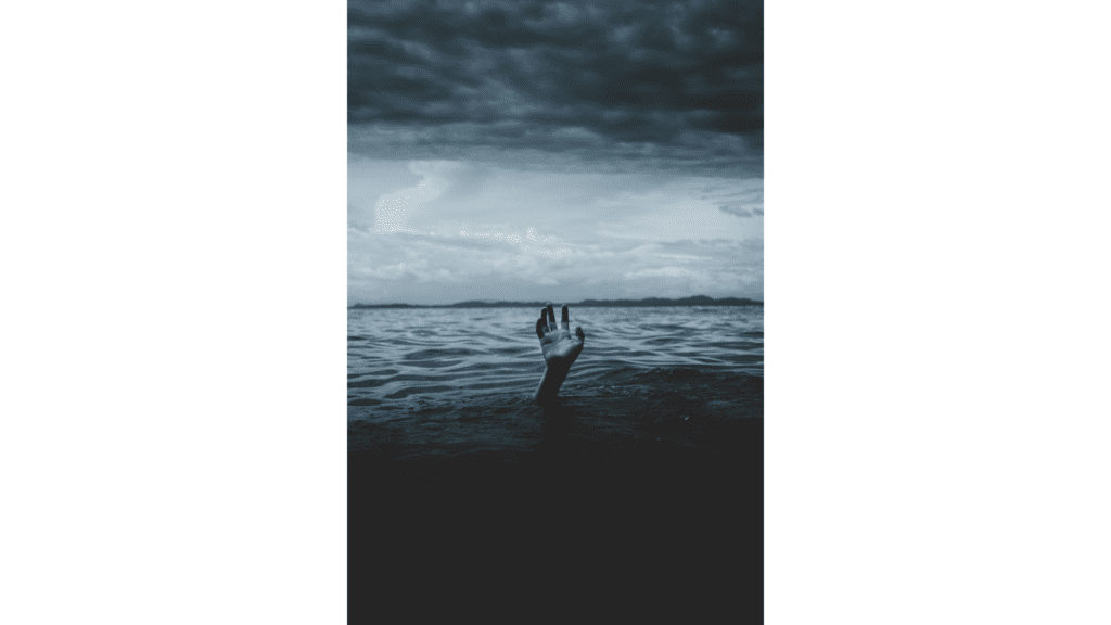 caregiver burnout picture shows hand sticking out above the ocean water