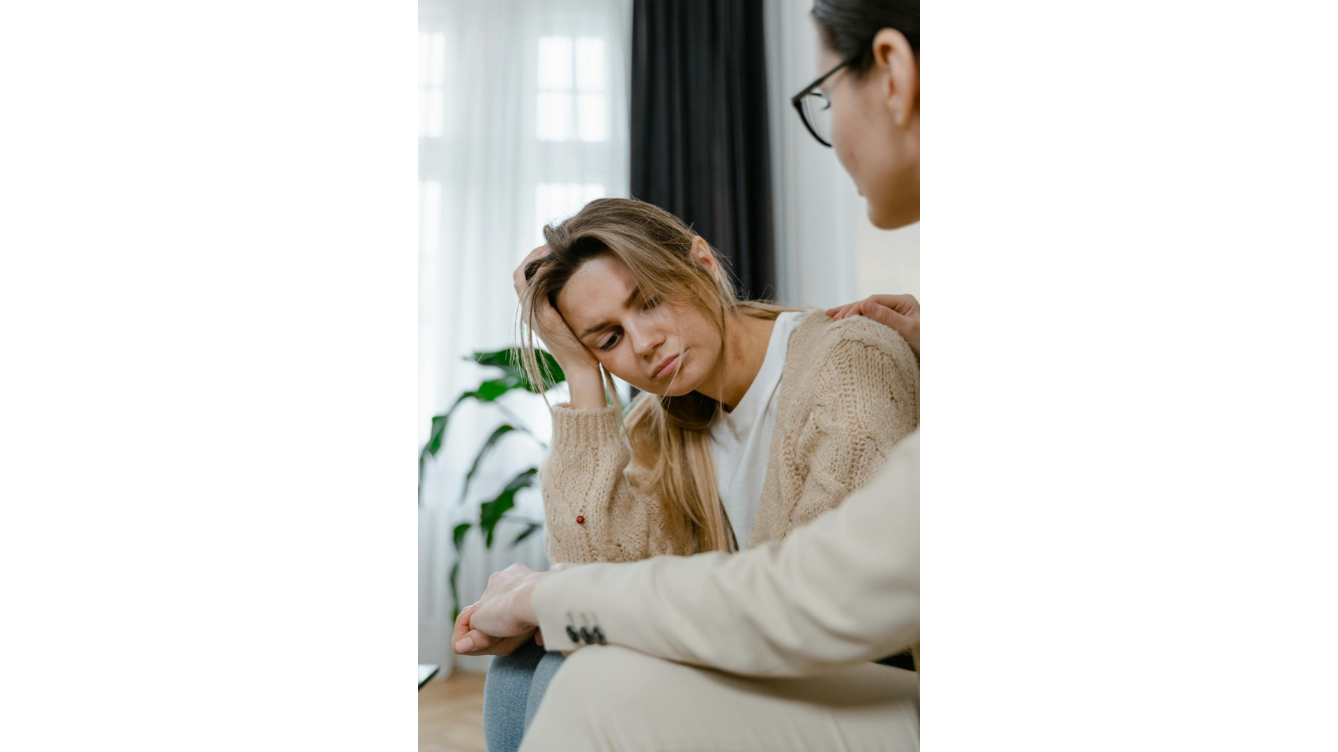 Woman experiencing caregiver burnout holding her head in her hand