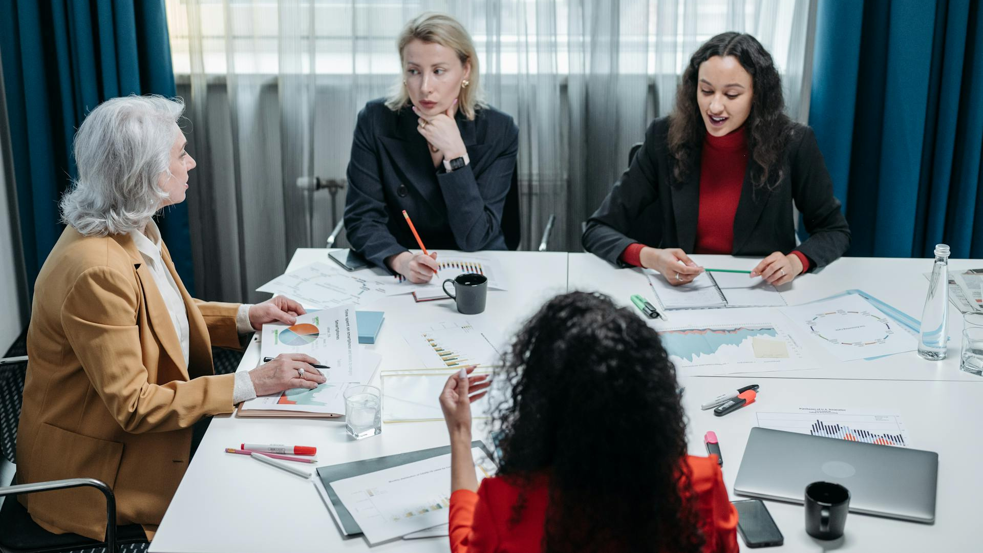 4 women having a meeting at work